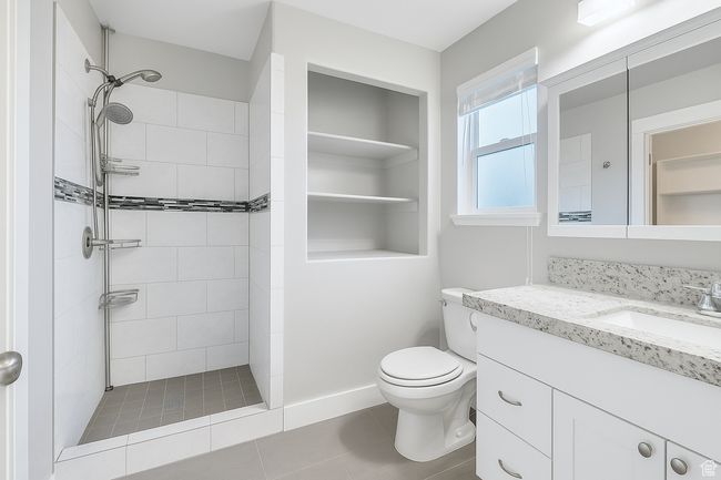 Bathroom featuring vanity and a tile shower | Image 10