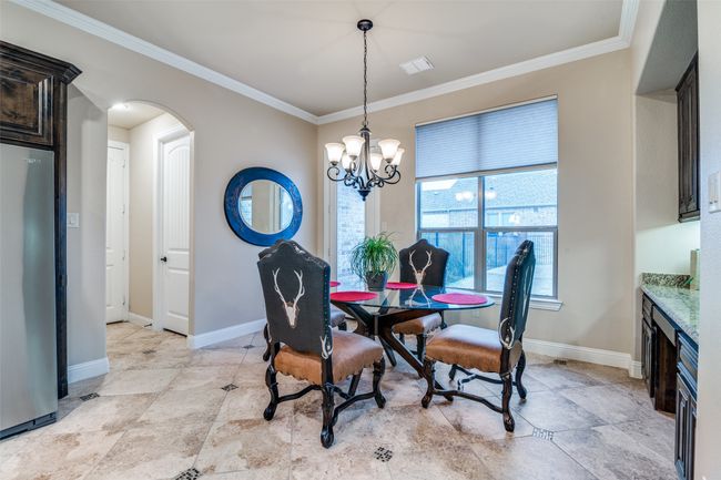 The breakfast area is spacious and leads to the utility room, the walk-in pantry and into the garage. | Image 18
