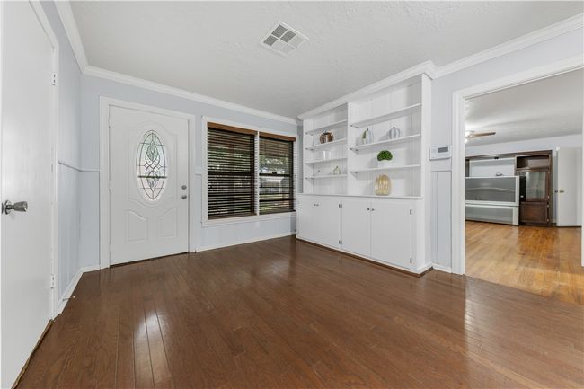 Foyer entrance featuring hardwood / wood-style floors, ceiling fan, ornamental molding, and a textured ceiling | Image 5