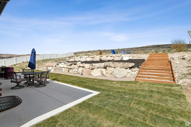 View of yard with a patio area and stairway | Image 4