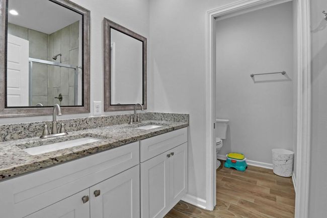 Primary bathroom has dual sinks and lots of storage | Image 13
