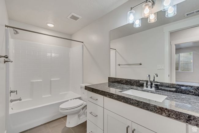 Bathroom with vanity, shower / bathtub combination, and tile patterned flooring | Image 25