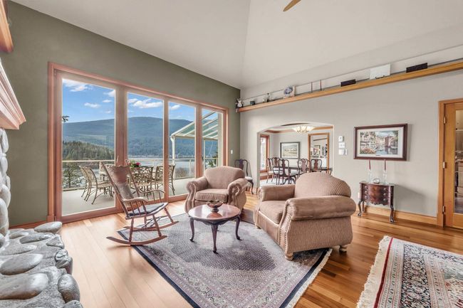 Living room featuring a mountain view, baseboards, wood-type flooring, arched walkways, and a notable chandelier | Image 16