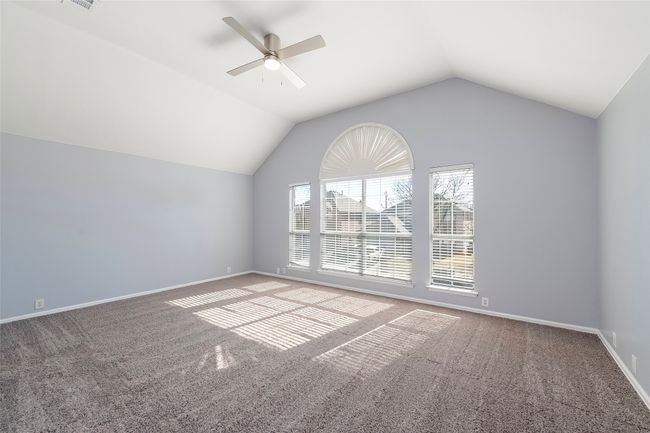 Bonus room with lofted ceiling, baseboards, carpet floors, and a ceiling fan | Image 31