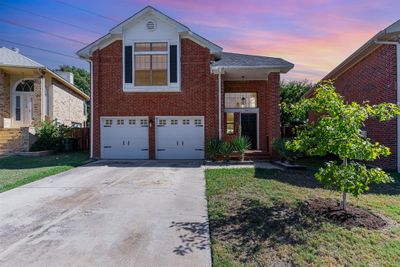 View of front of property with a lawn and a garage | Image 2