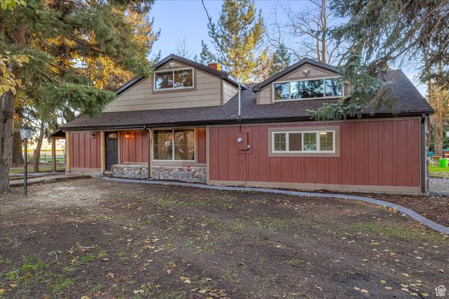 View of front of house with roof with shingles and board and batten siding | Image 11