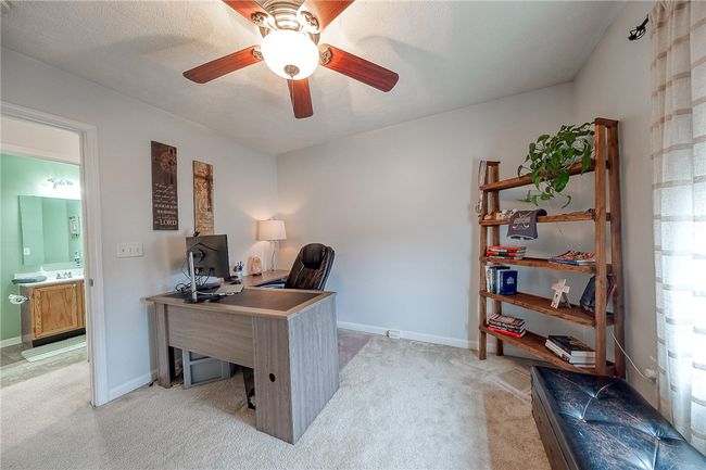 First spacious bedroom being used as an office | Image 14