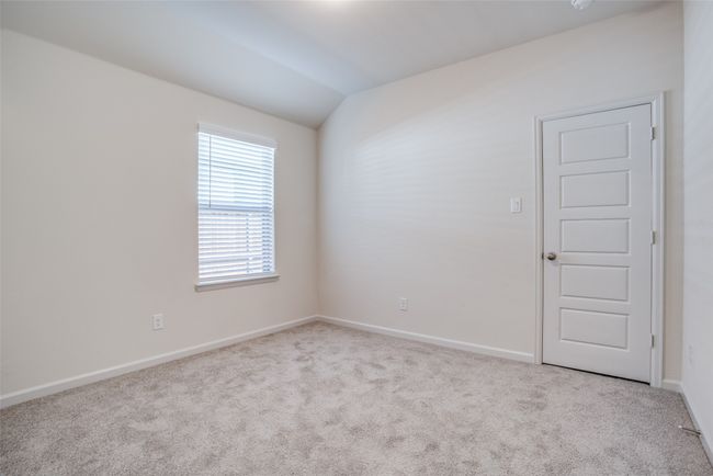 Carpeted spare room featuring vaulted ceiling and baseboards | Image 18