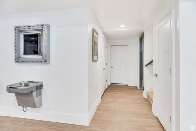 Hallway featuring light wood-style flooring, stairs, and recessed lighting | Image 69