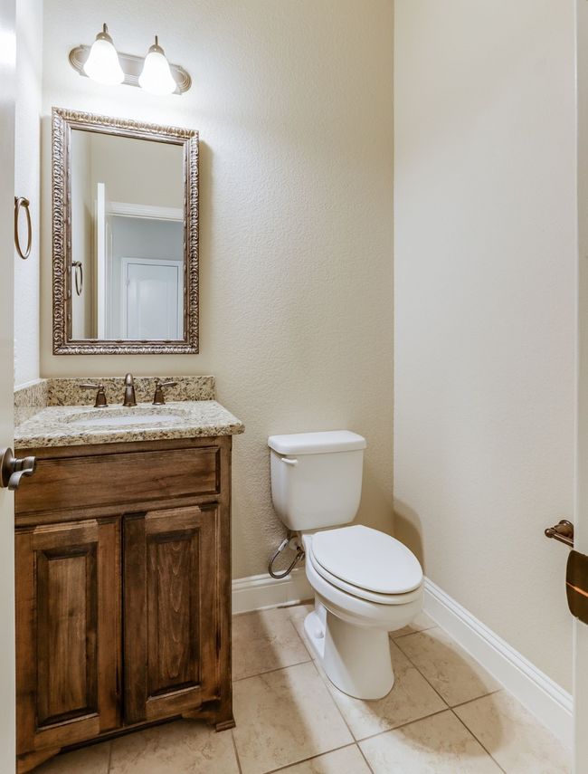 Bathroom with vanity, a textured wall, and tile patterned floors | Image 19