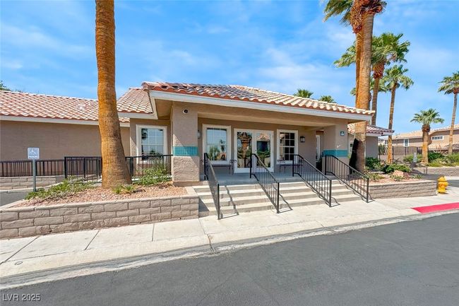 View of front of house featuring a tiled roof, stucco siding, and covered porch | Image 37
