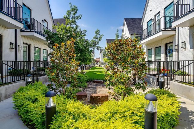 View of yard featuring a balcony and a residential view | Image 32