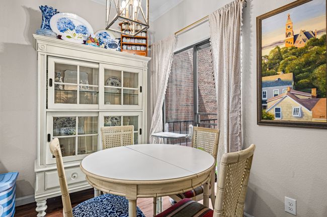 Dining area featuring crown molding, a chandelier, and wood finished floors | Image 13