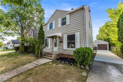 View of front of property featuring a garage, a front lawn, and an outbuilding | Image 2