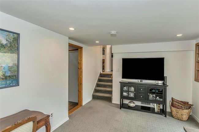 Den featuring recessed lighting, baseboards, stairway, and carpet floors | Image 17