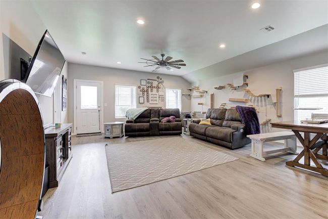 Living room featuring ceiling fan, light wood finished floors, and recessed lighting | Image 6