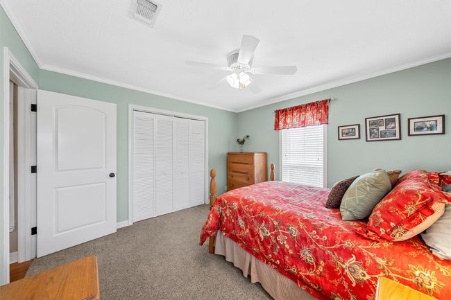 Bedroom featuring ornamental molding, a closet, carpet flooring, and ceiling fan | Image 25