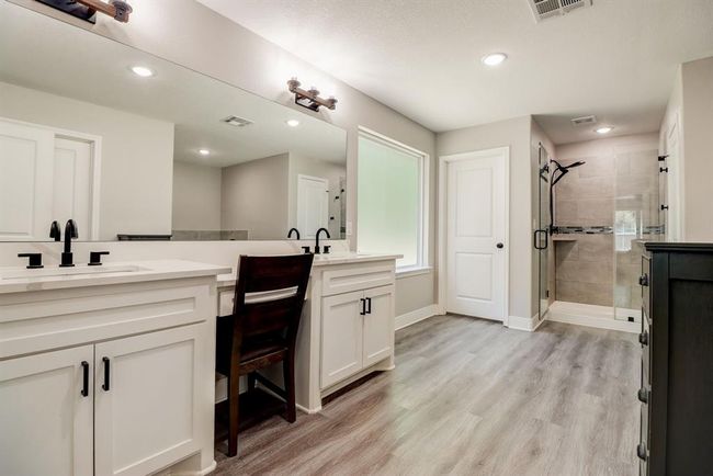 Primary bath features his and her sinks complete with vanity area | Image 25