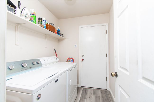 Clothes washing area with independent washer and dryer, light wood-style flooring, and laundry area | Image 17