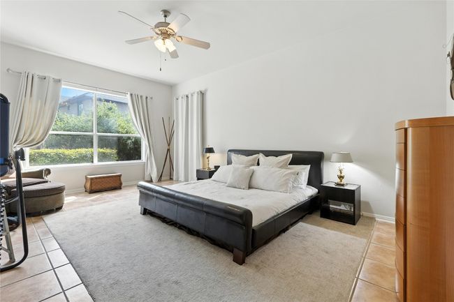 Bedroom featuring light tile patterned floors and ceiling fan | Image 20