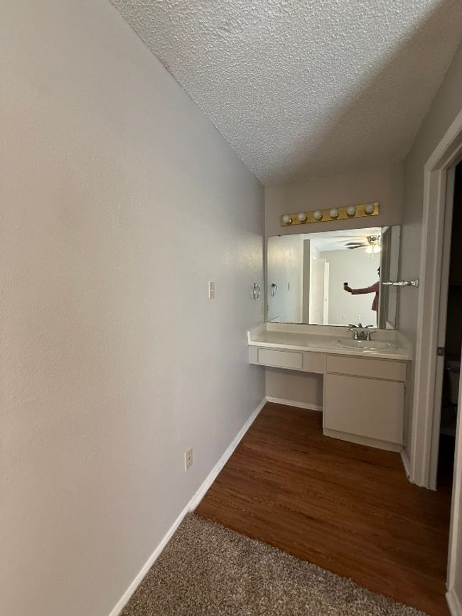 Bathroom featuring a textured ceiling and vanity | Image 19