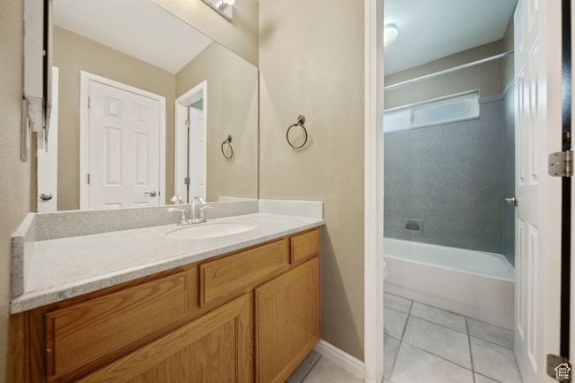 Bathroom with vanity, bathing tub / shower combination, and tile patterned floors | Image 22