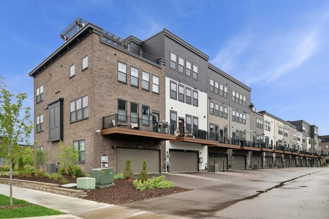 End unit of this 3+ story home features a rear entrance to a two-car garage, giving you two more guest parking spaces, plus ample street parking along the side and front of the home. | Image 35