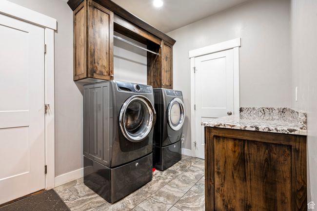 Laundry area with washing machine and dryer, baseboards, and cabinet space | Image 22