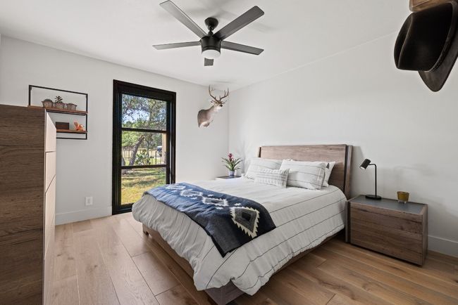 Bedroom featuring hardwood / wood-style flooring and ceiling fan | Image 32