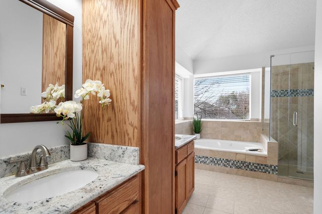 The updated primary bath has tons of storage and two vanities. | Image 27