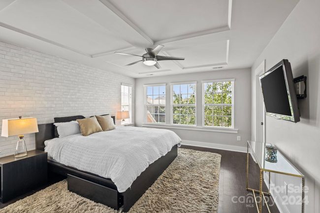 Upper level features primary bedroom suite with feature wall. | Image 16