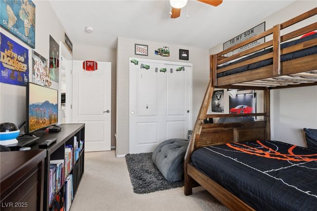 Bedroom featuring light colored carpet, a closet, and a ceiling fan | Image 40