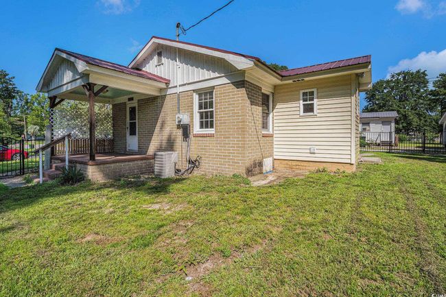 Back of property with brick siding and a​​‌​​​​‌​​‌‌​‌‌​​​‌‌​​‌‌​‌​​​​​‌ porch | Image 16
