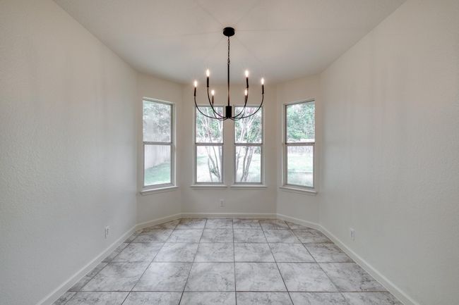 Unfurnished room with a chandelier and baseboards | Image 10