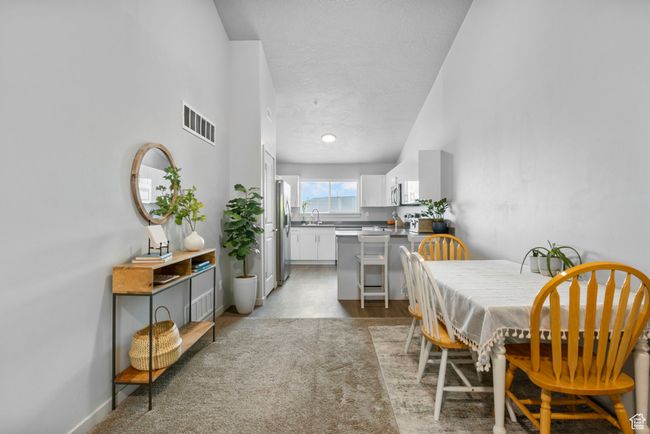 Dining space with a textured ceiling, baseboards, and visible vents | Image 11