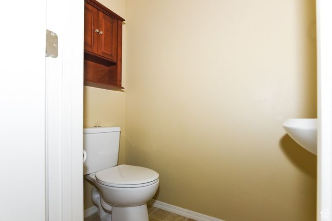 Bathroom featuring baseboards, toilet, and tile patterned flooring | Image 17