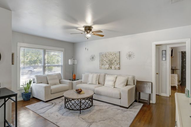Living room featuring ceiling fan and wood-type flooring | Image 7