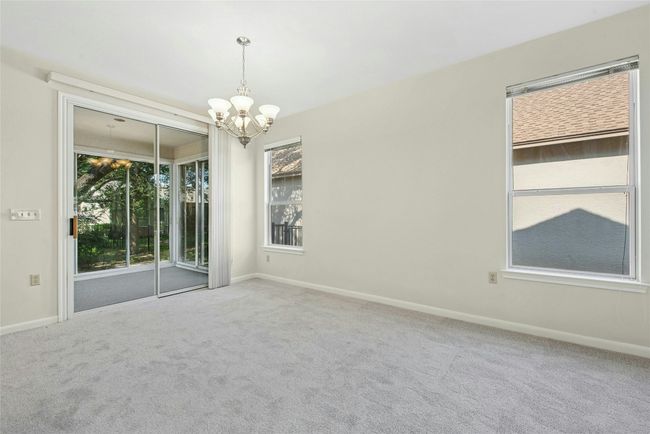 Spare room with a chandelier, carpet flooring, and baseboards | Image 8