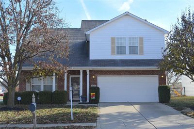 Welcoming Front Elevation with Brick, Vinyl, & Shutters. Coach Lights, Address Stone, & Keyless Entry along with an Insulated Garage Door | Image 1