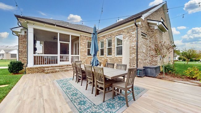 Spacious outdoor dining area with room for everyone—perfect for entertaining and just steps away from your custom outdoor kitchen! | Image 56