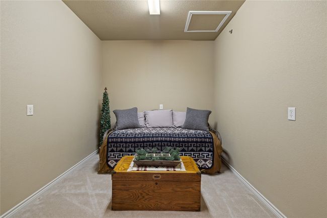 Bedroom with carpet floors, attic access, and baseboards | Image 19