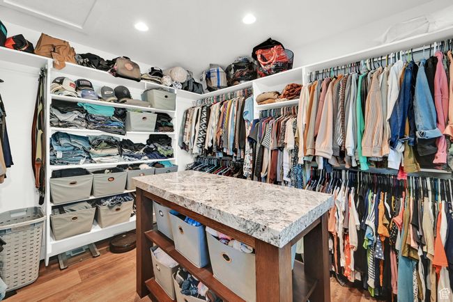 Walk in closet with light wood-type flooring | Image 23