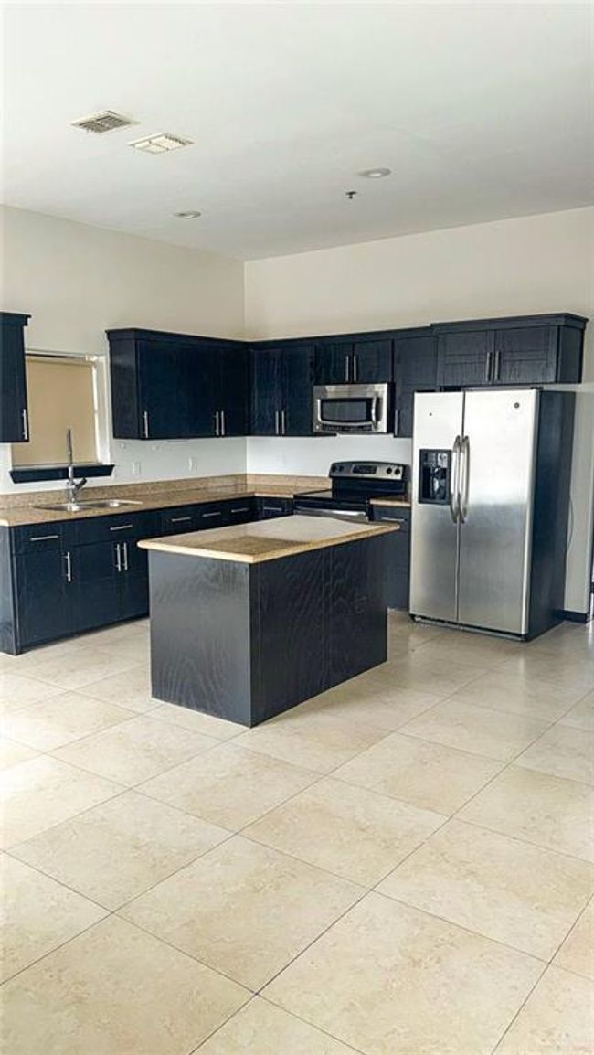 Open concept Kitchen with stainless steel appliances, open up to dining area and living room. | Image 6