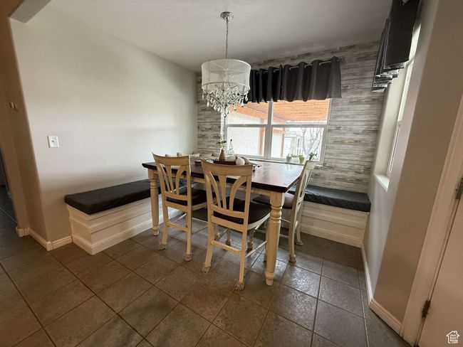 Dining space with a chandelier and baseboards | Image 17