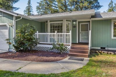 The covered front porch is a sweet way to enjoy your morning cup of coffee in the sunshine! | Image 3