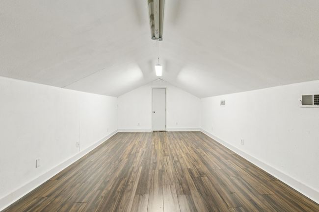 Additional living space with vaulted ceiling, dark wood finished floors, and baseboards | Image 25