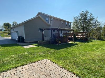 Back of house with a lawn and a deck | Image 3