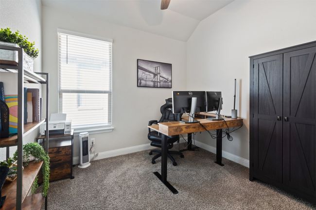 Carpeted office space featuring vaulted ceiling, ceiling fan, and baseboards | Image 9