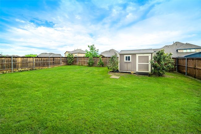 View of yard featuring a storage shed and an outbuilding | Image 34