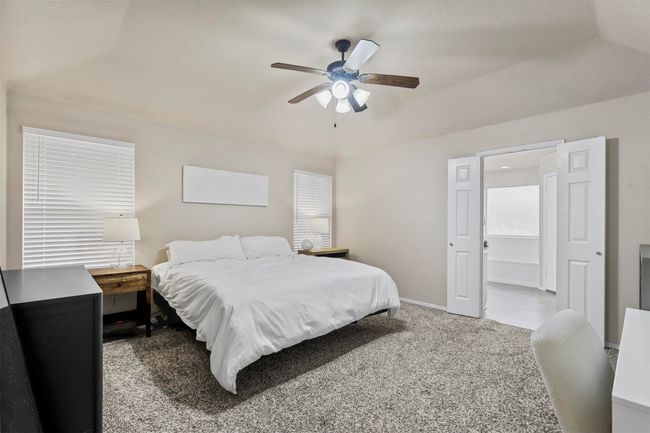 Carpeted bedroom with ceiling fan and baseboards | Image 21